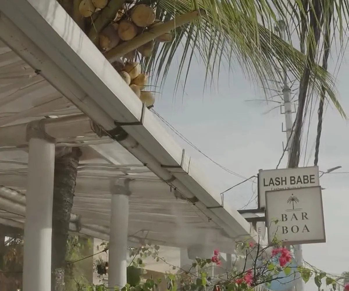 A misting line running under a cafe awning on a Canggu street