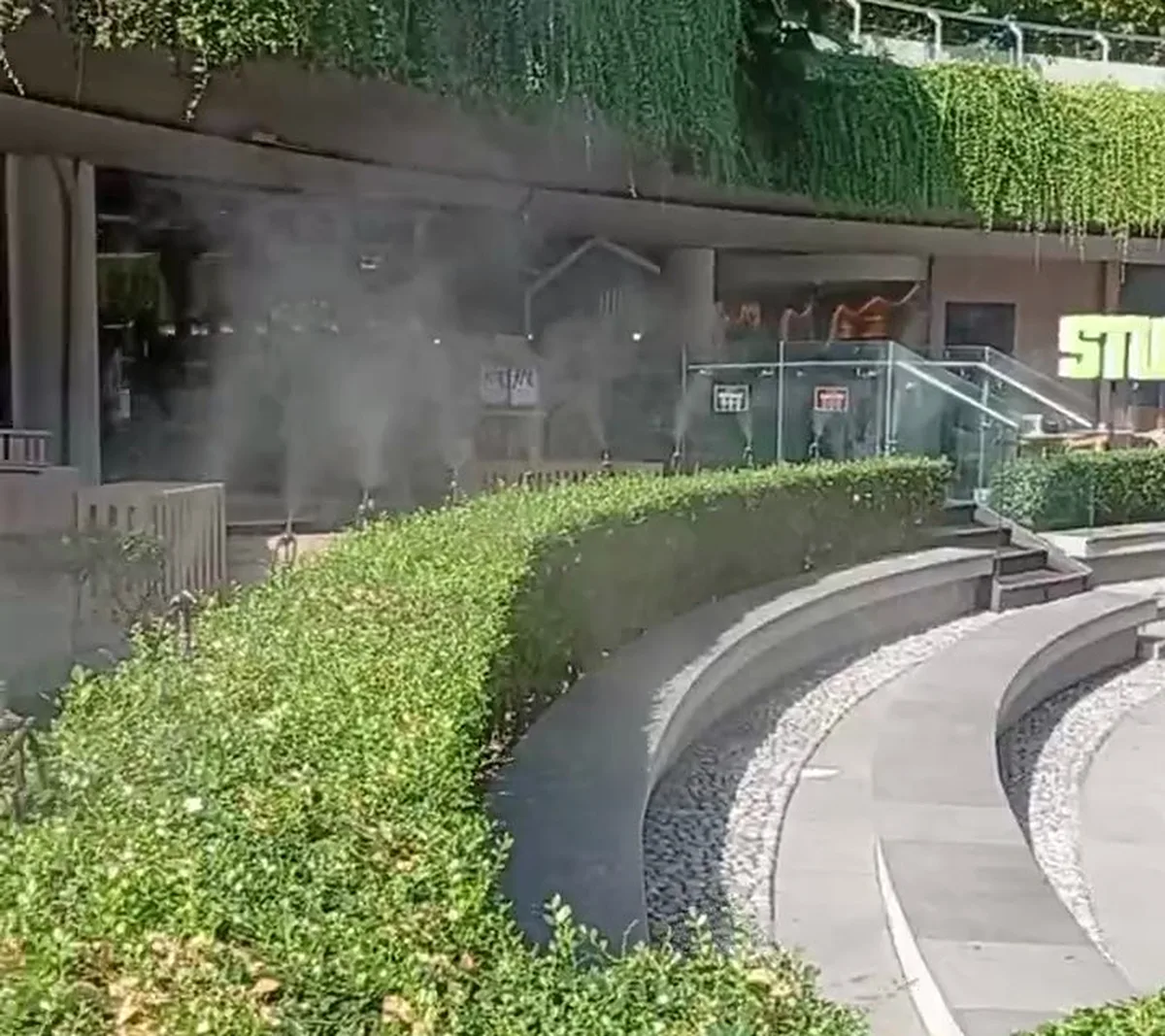 Mist over the amphitheatre steps and greenery at W Bali - Seminyak